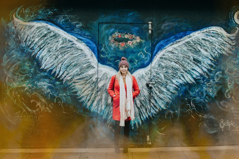 Arte urbana com asas de anjo em Bangor, com mulher ao centro, representando a proteção oferecida por um seguro de vida